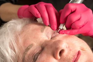 close up of woman getting lower eyeliner micro-pigmentation