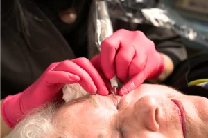 close up of woman getting upper and lower eyeliner micro-pigmentation