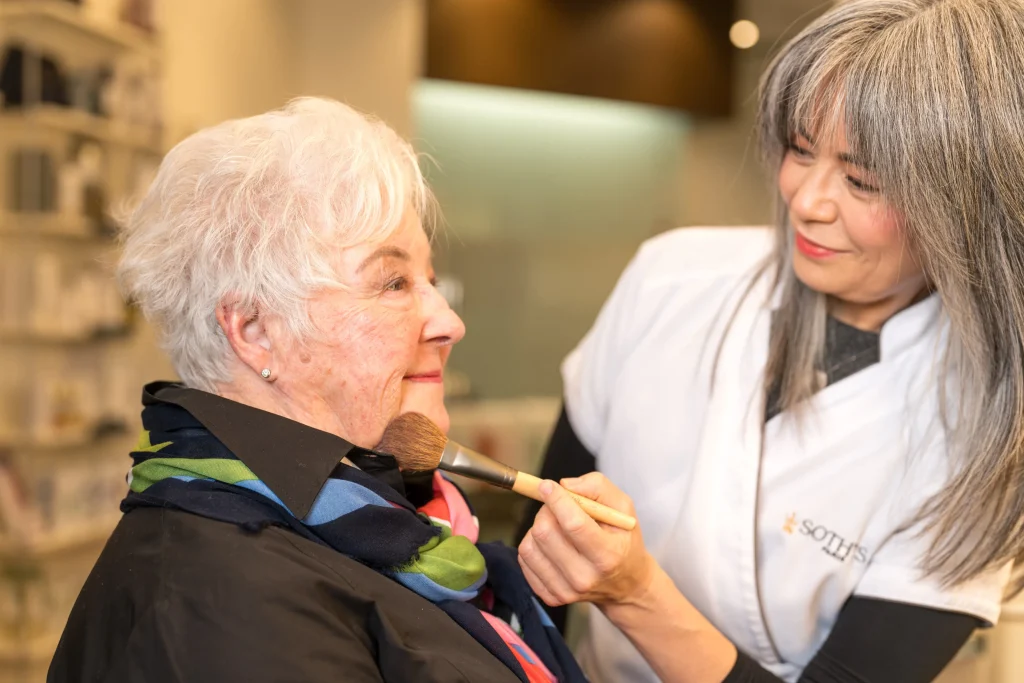 woman having her makeup done by a professional makeup artists for a special occasion